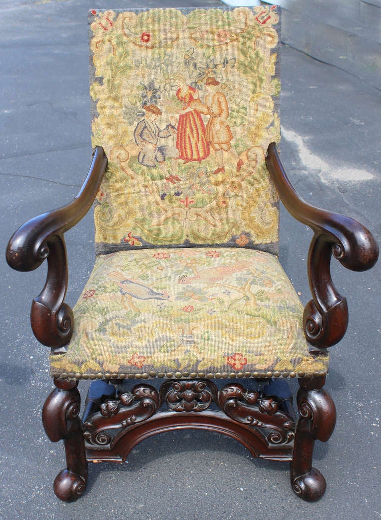 Pair of  English, 19th century  William & Mary Style armchairs covered with rectangular muted polychrome tapestry depicting exotic birds and figures on a dense foliate landscape.  Bold scrollwork and nicely carved and arched front stretcher.