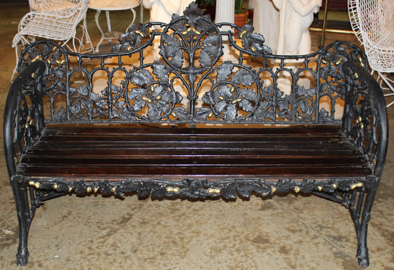 Cast iron oak leaf and ivy design with acorns, wooden slat seat. See Coalbrookdale catalogue page 271 for similar bench. The original design, number 119253, was registered and patented by the Coalbrookdale Iron Foundry at the Public Record office on