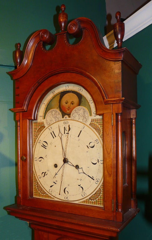 Federal style cherry case tall clock most likely by Jacob Diehl of Bedford, PA.  Arched door flanked by turned columns opening to a wonderful American painted four-handed dial.