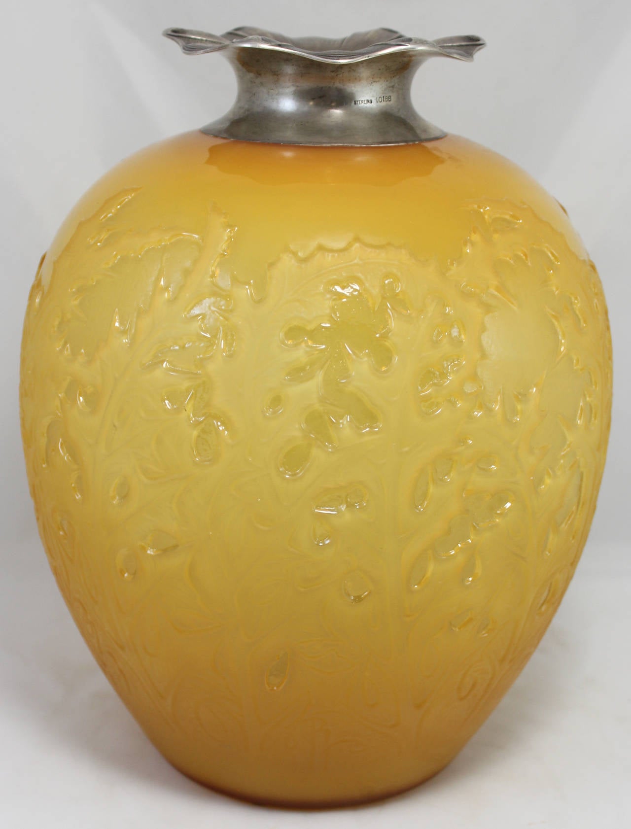 A magnificent glass amber vase in the Acanthus pattern, signed on base R. Lalique. Circa 1920-1925.  Rare form with beautiful color. Sterling top is a later addition.