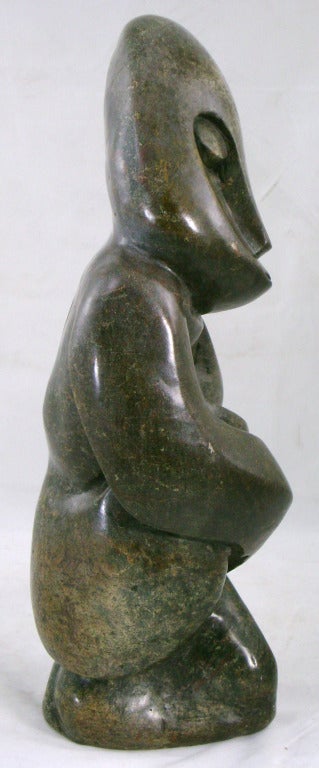 Wonderful hand carved stone figure from a single stone, probably 20th c African, is inscribed “Onsem M” near the base. The stone used is primarily made up of deep green and gray colors, with highlights of brown and red in spots. s. Dimensions: 17” h