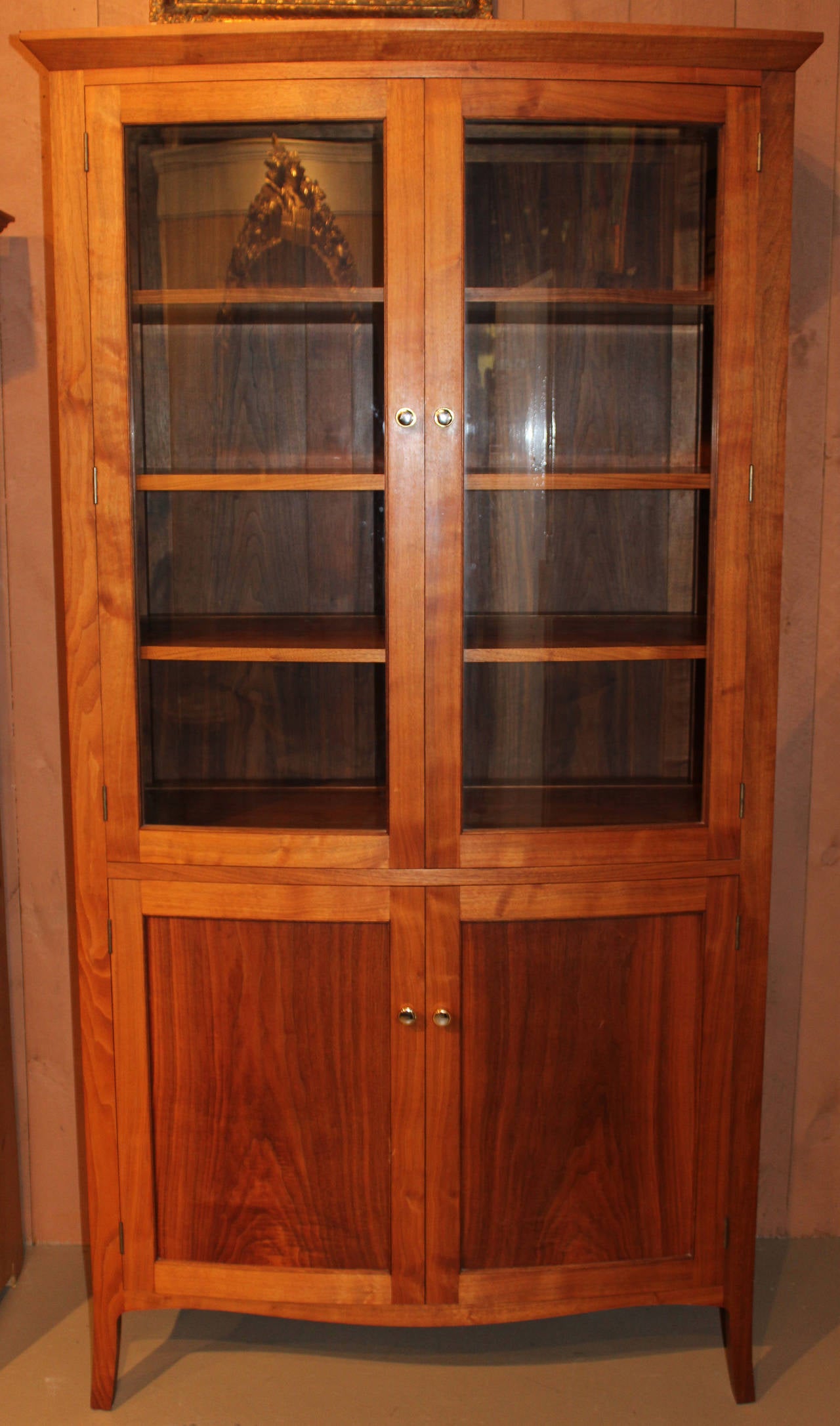 An exceptional cherry cupboard by David Margonelli with a two convex glass doors opening to four adjustable shelves with an integral lower section with cabinet doors opening to reveal conforming drawers. Beautifully crafted with paneled back.