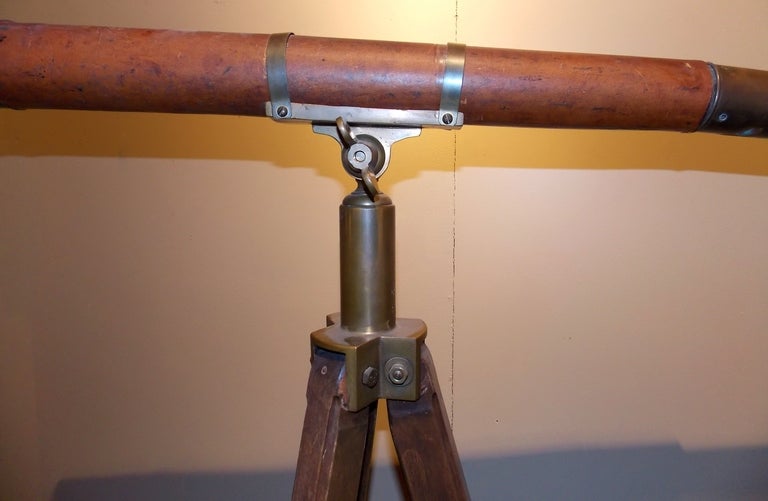 19th c. Negretti & Zambra telescope mounted on a wooden & brass tripod.  Body of telescope is wrapped in leather.  Great patina to wood and brass.  Inscribed 