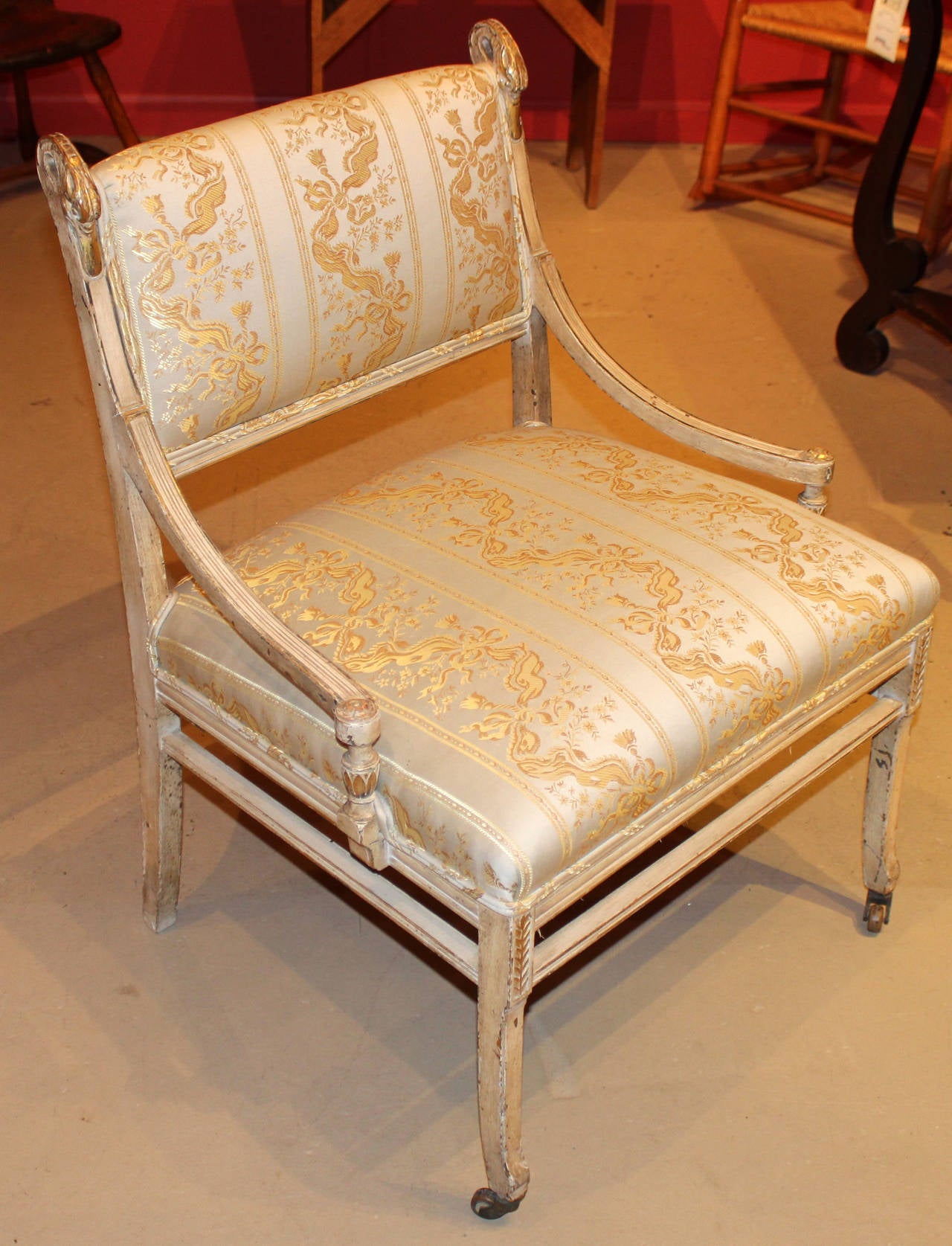 A fine example of an early 19th century French style upholstered side chair with carved swan heads, painted and gilt surface, and low arms. Provenance: Possibly from the Vanderbilt suite.