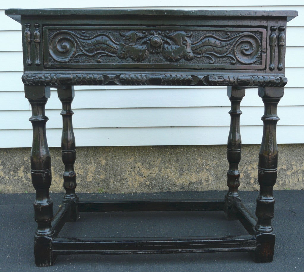 19th c. Jacobean style side table in ebonized oak.  Nicely carved and fitted with drawer. Made with 17th century elements.