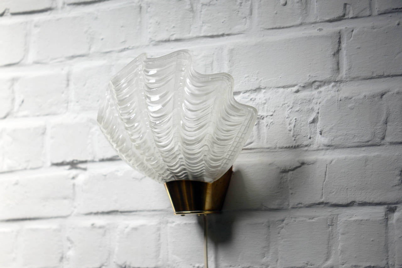 Swedish glass shell and brass pair of wall lamps.
