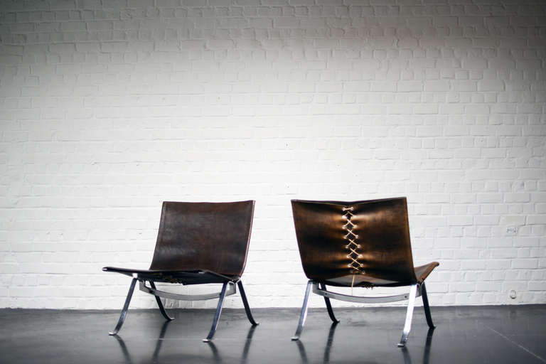 One pair of patinated leather armchairs