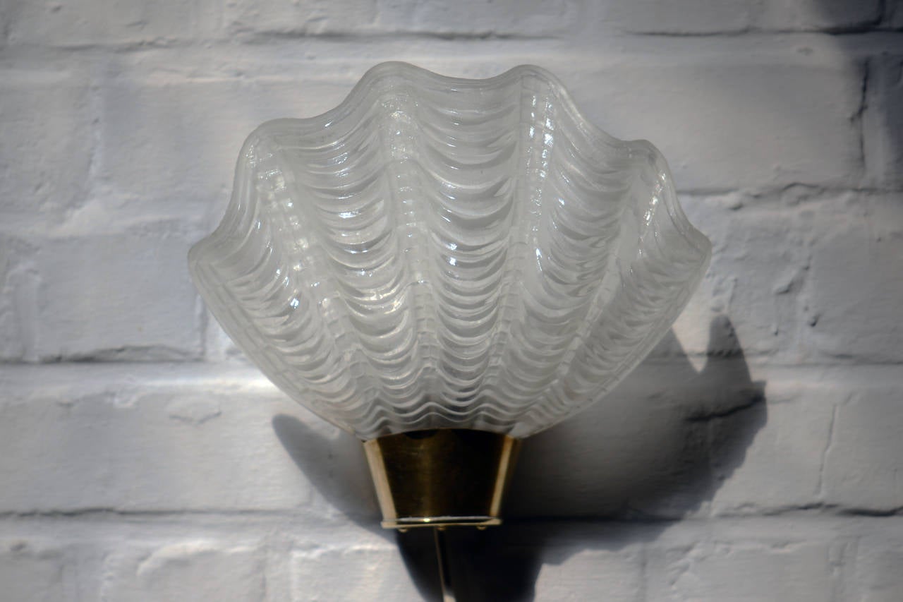 Two pair of frosted glass shell and brass structure wall lamps made in Sweden in the 1930s.