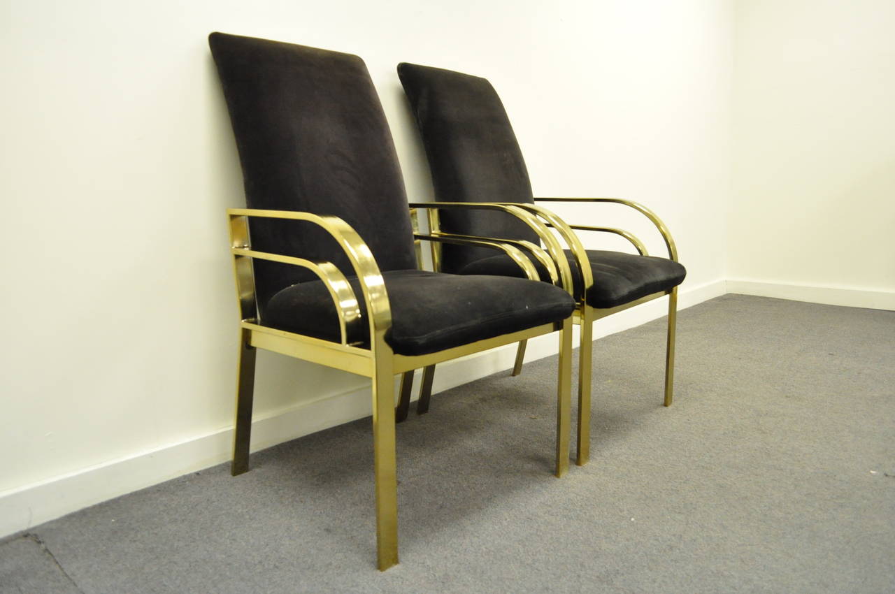 Very unique pair of vintage, brass plated, Hollywood Regency armchairs in the manner of Pierre Cardin. The pair features sculpted metal frames, angled backs, and great Art Deco / Mid-Century Modern form. The arm height is 23.5