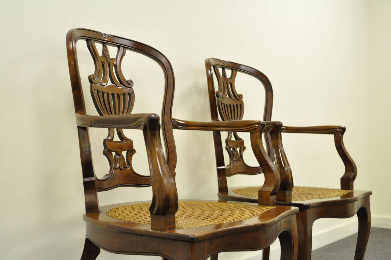 Wood Pair of Hand-Carved Italian Venetian Cane Seat Arm Chairs in the French Taste For Sale