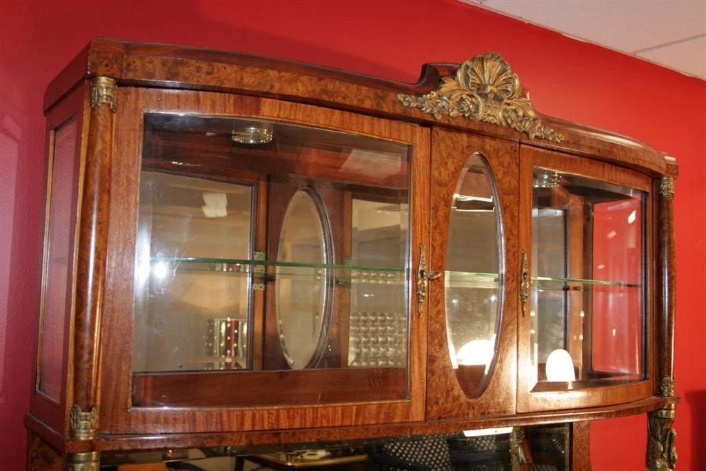 Breathtaking Antique French Marble Top Burled Olive Wood Server/Sideboard from the late 1800's - early 1900's. This unique item features very detailed bronze swans holding up the glass and mirror lighted curio top and is signed L. Lasserre in the