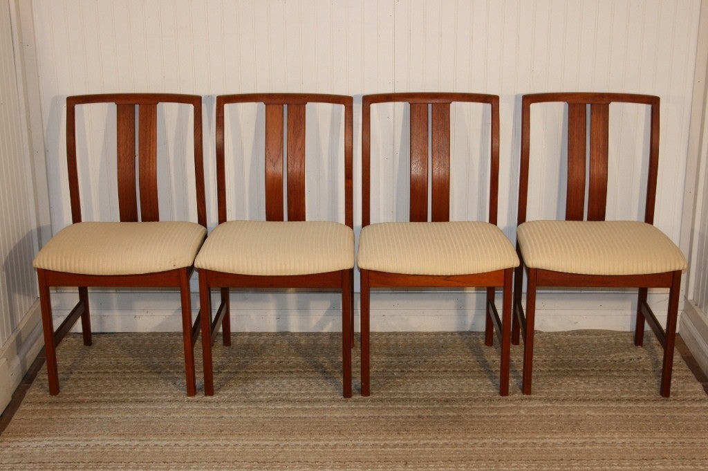 Set of 6 Mid Century Danish Modern Teak Dining Chairs having stunning modernist lines. Set includes 2 arm chairs and 4 side chairs with unique sculpted backs, and beautiful wood grain throughout. The style is similar to that of Finn Juhl or other