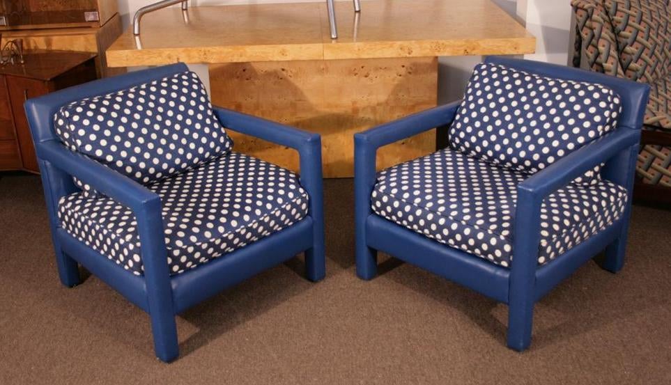 Original upholstered vintage Mid-Century Modern armchairs in fun blue polka dot fabric with vinyl wrapped frames. Price is for the pair. Each chair measures 28