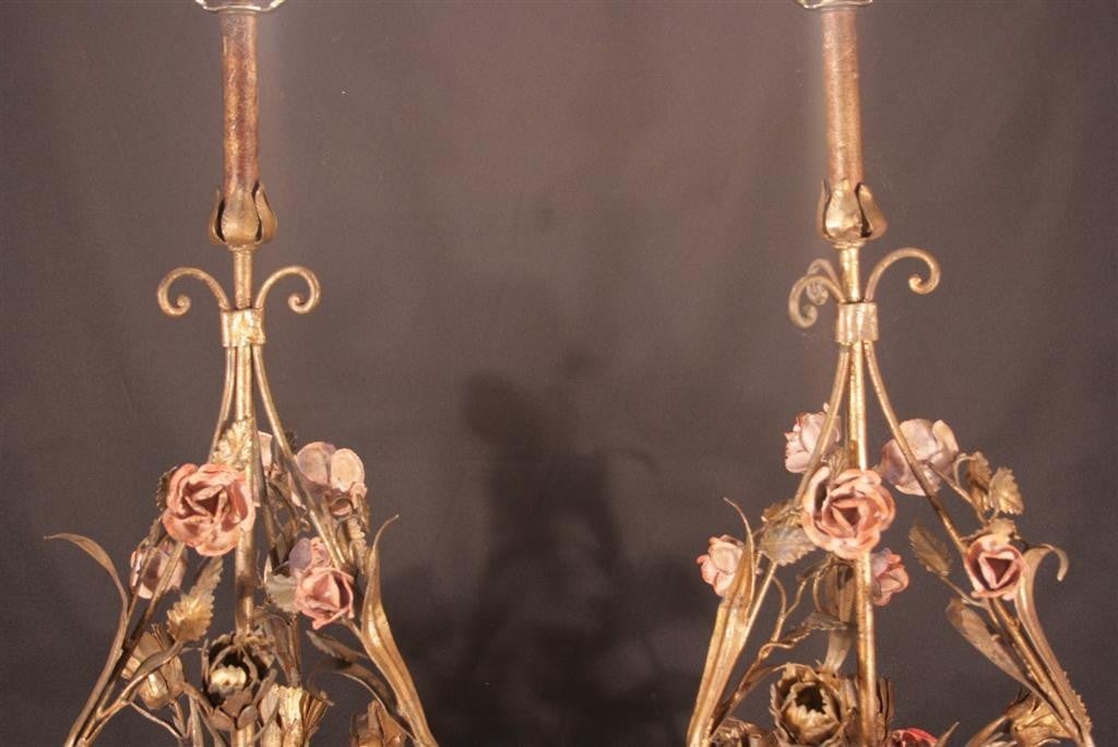 Pair of Stately Shabby Chic Italian Tole Metal Handpainted Floral Table Lamps dating back to around the 1940's. This large pair of lamps features monumental bouquet frames, original handpainted flowers, metal and wood column form bases, and a very