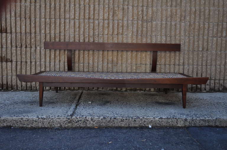 Very unique 1960's sculpted walnut Danish Modern daybed / sofa with curved front rail, tapered legs, and sleek modernist form.