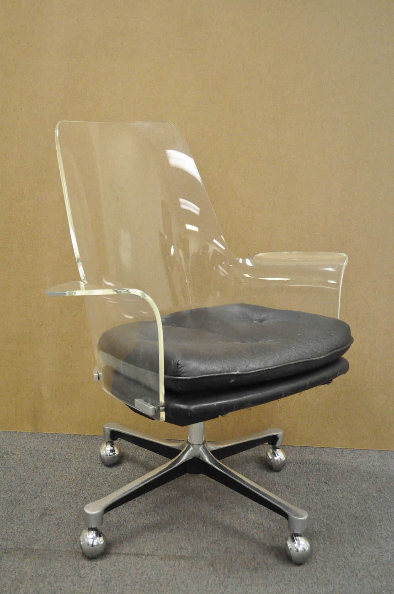 Very Cool Vintage, Mid Century Modern,  Sculpted Clear Lucite Swivel Arm Chair. The chair features a thick bent lucite seat and back with flared arms, and aluminum swag base. Very similar to pieces designed by Erwine & Estelle Laverne and Vladimir