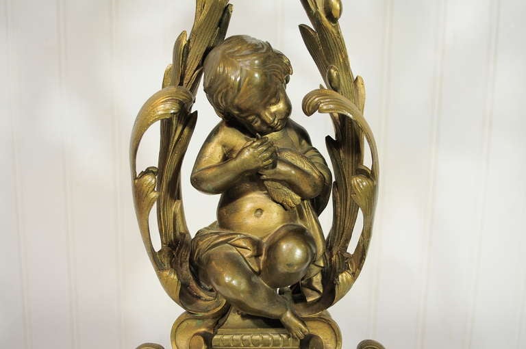 Beautiful 19th C. French Bronze Figural Candelabra Lamp in the Rococo Taste with an adorable cherub at the center. Item features  seven ornate lighted candelabra arms, ornate bronze detailing with the most adorable cherub / putti at the center