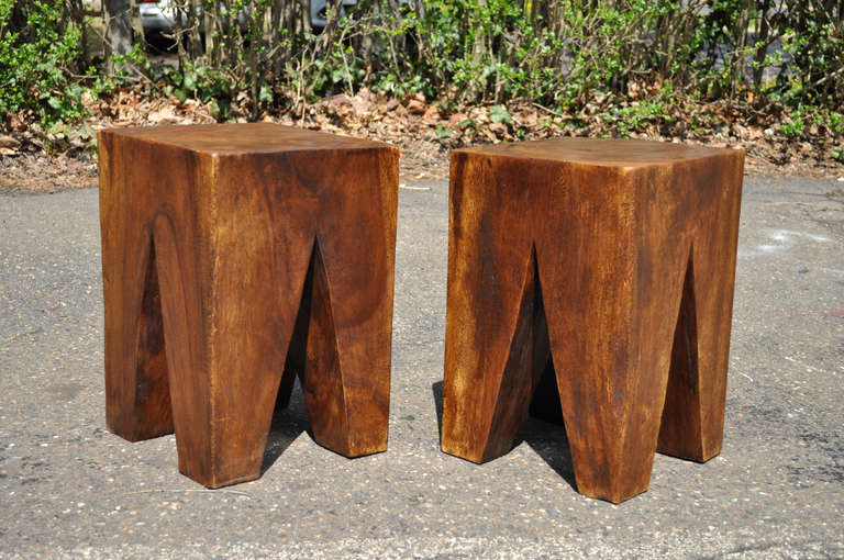 Pair of Unique Modernist Solid Wood Stools or Side Tables. The pieces are nice, heavy wood, with the legs cut out to form a sleek modern look that emphasizes the natural beauty of the wood grain. The pair looks to be greatly influenced by the