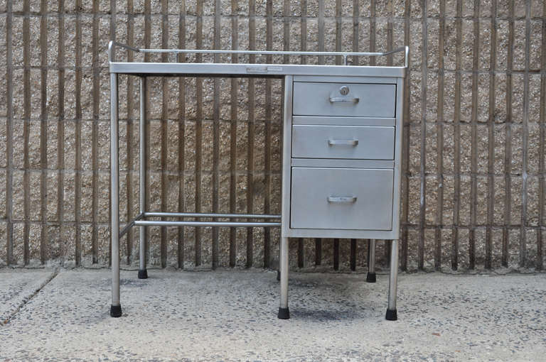 Very Cool Vintage Industrial Stainless Steel Army Medical Desk by Shampaine Company with steel gallery and clean modernist lines. 

Measurements:  31.25