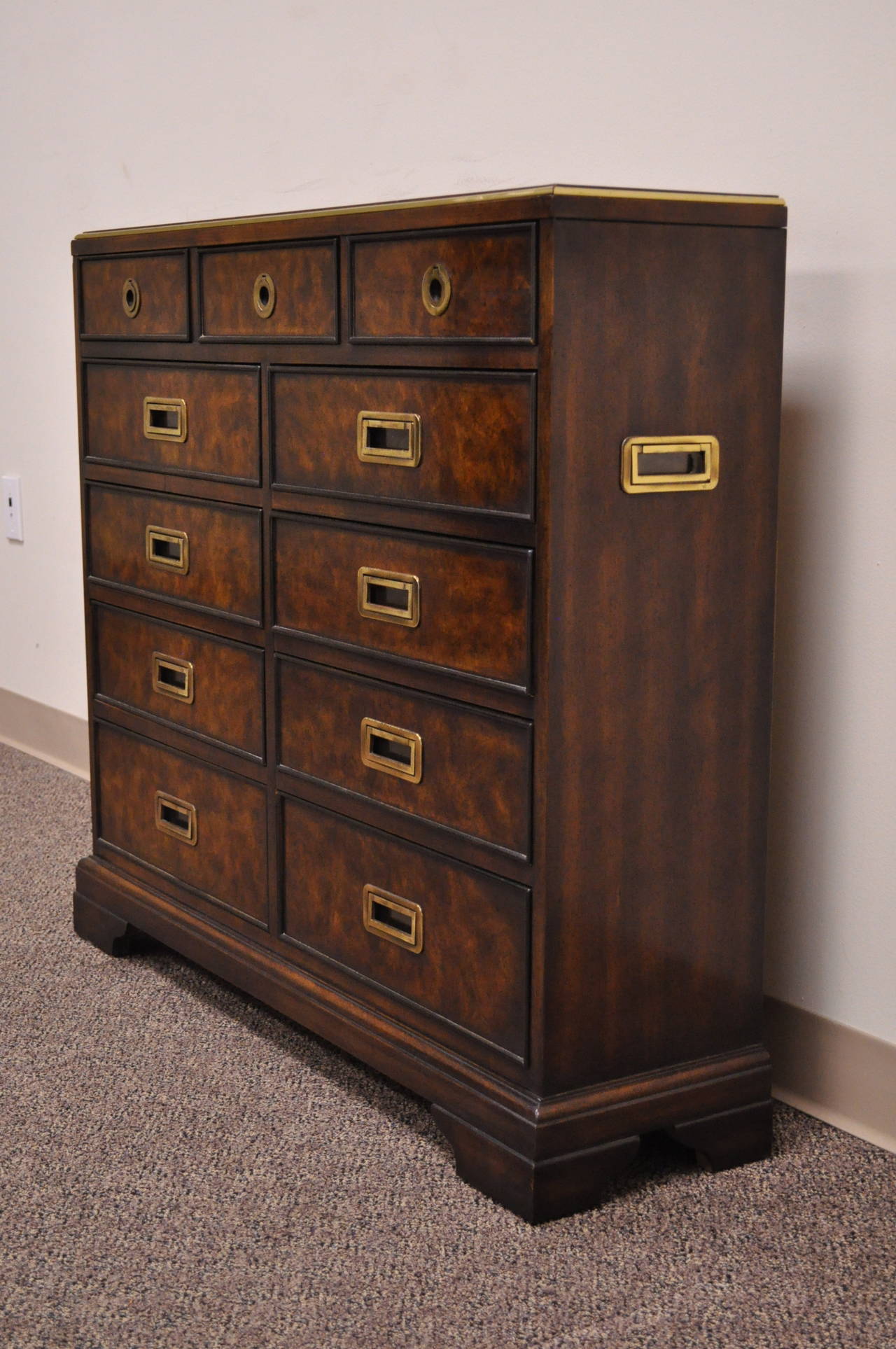 Very Unique Vintage, Tooled Leather Top, Narrow Campaign Style Chest by Drexel Heritage. This piece features 9 dovetailed drawers, inset brass pulls on the drawer fronts and sides, gold gilt trim, and beautiful woodgrain. Chest would work wonderful