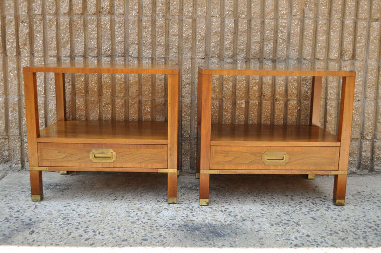 Pair of Vintage Milling Road for Baker Furniture Nightstands. The nightstands feature a very nice campaign style with a striking, geometric figured wood grain, lovely brass inset hardware and foot caps, as well as banded drawers fronts and tops and