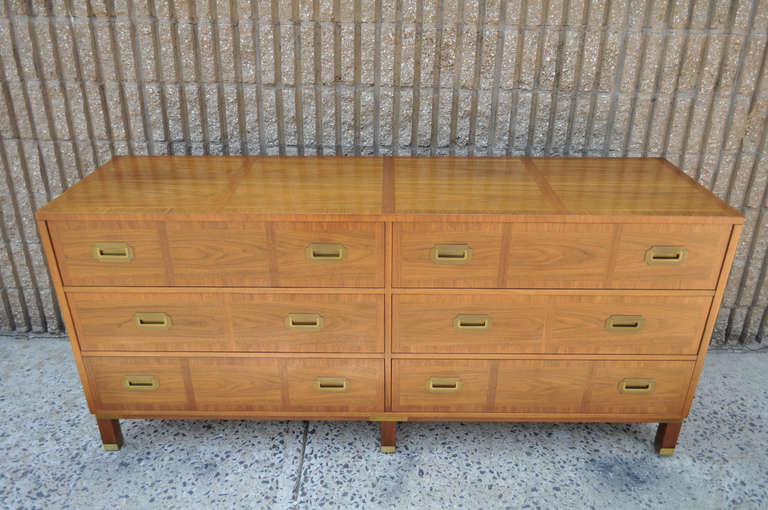 Vintage Mid Century Modern Milling Road Tall Dresser by Baker. The dresser features a very nice Hollywood Regency / campaign style design with striking, figured wood grain, 6 dovetailed banded front drawers, banded top, and lovely brass accents