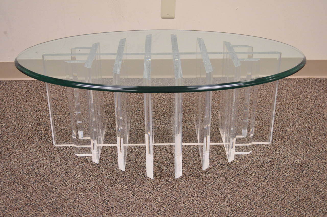 Very unique vintage Mid-Century Modern Lucite coffee table with a thick and heavy grid form sculptural base in the manner of Jeffrey Bigelow. Item features a oval beveled edge. 75