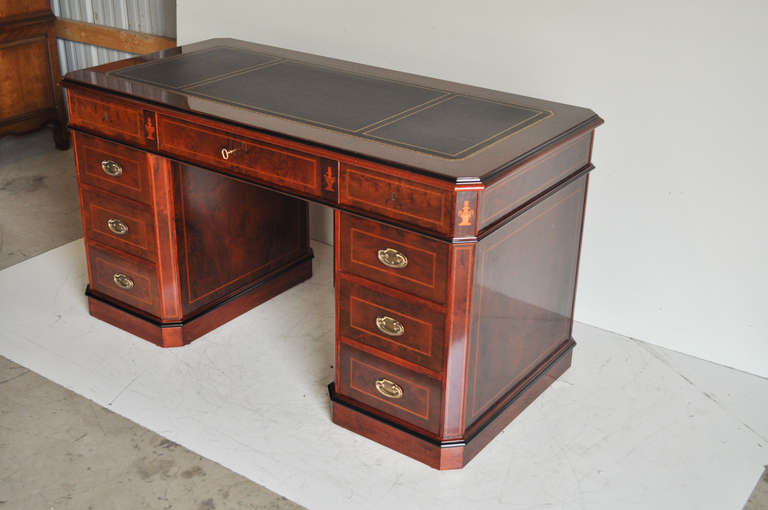 20th Century Tooled Leather Top three Part Knee Hole Desk by Amboan in the Federal or Neoclassical taste. This remarkable desk features, inlaid urn form accents, finished back, dovetailed drawers, tooled black leather top with gold gilt border,