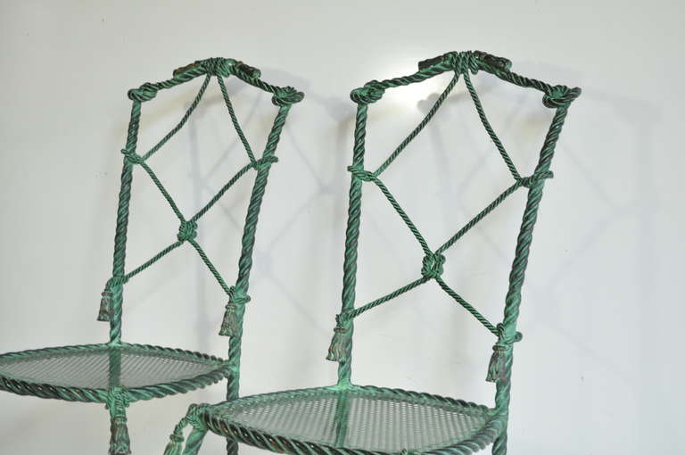 Truly glamorous pair of vintage Italian Hollywood Regency green patinated Iron rope and tassel form side chairs with remarkable lines and stunning form. The chairs are constructed of heavy iron in the form of rope, knots, and decorative tassels