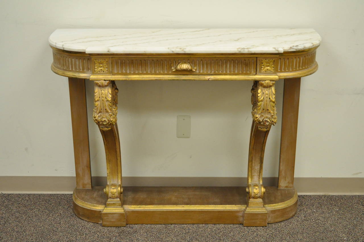 Stunning French 19th Century Gilt Wood Marble Top Console Table in the Louis XV Taste with single drawer. This item features a scrolling floral drape and acanthus carved base which supports the shaped white marble top and single hand dovetailed