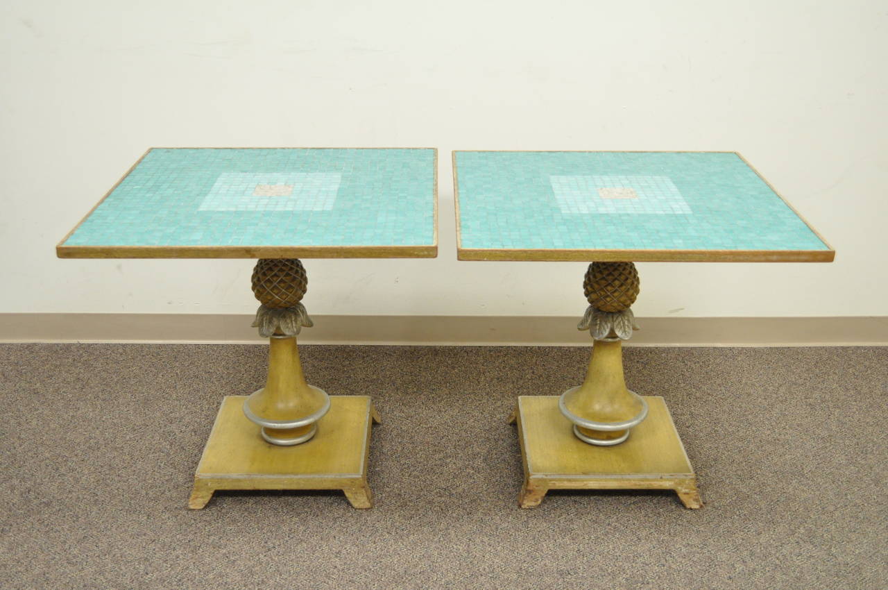 Remarkable pair of Vintage, Italian Hollywood Regency, Tile Top Pineapple Form Tables. This stunning pair features aqua blue and white mosaic tile tops with polychrome painted carved pineapple pedestal bases. The size is very versatile and can be