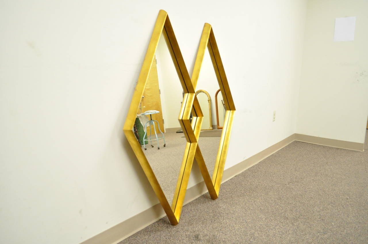 Vintage Hollywood Regency/Mid-Century Modern interlocking double diamond wall mirror attributed to Labarge. Item features a deep wooden frame with gold leaf finish in the highly sought after interlocking diamond form.