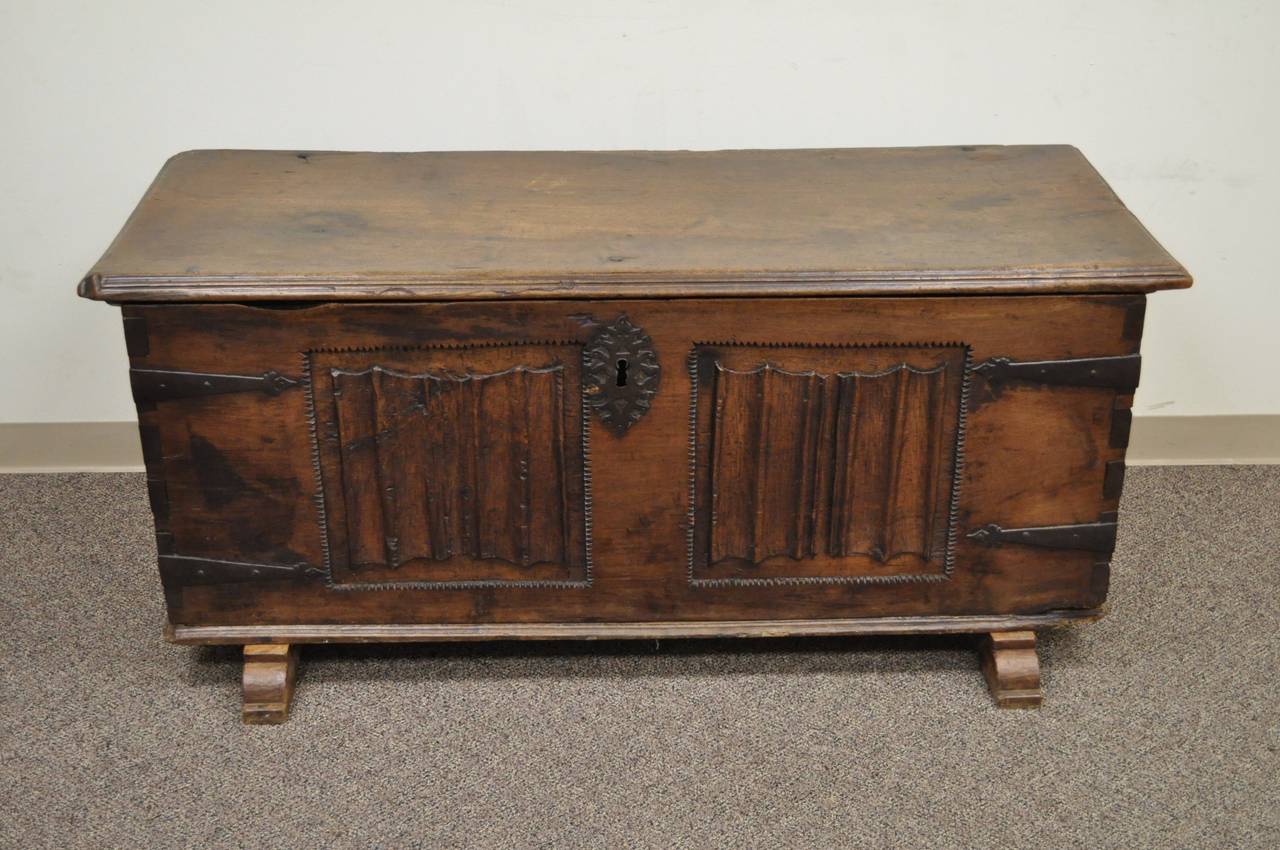 Large 16th Century Antique Dovetail Constructed Gothic Renaissance Chestnut Coffer Chest Trunk. Chest features a minimal yet interesting hand carved detailing on the front panel, hand wrought iron hardware, a very thick and solid carved wood lid