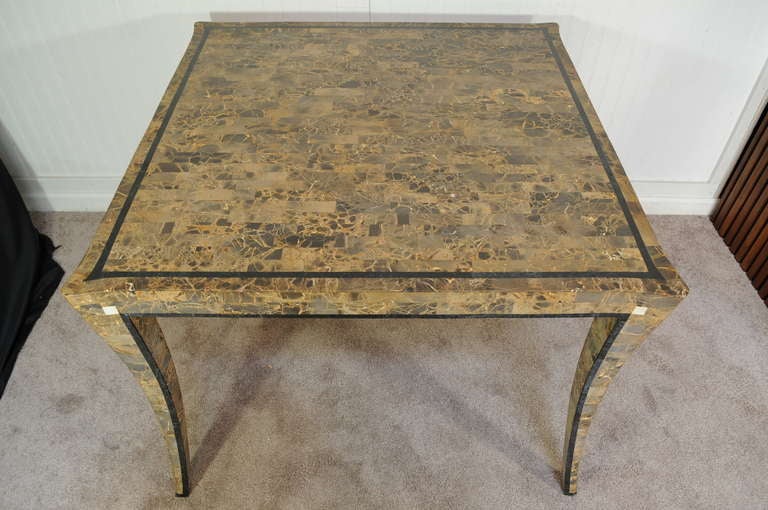 Beautiful Tessellated Stone Center/Game Table with Curvaceous Klismos Legs and intricately hand inlaid fossil stone attributed to Maitland Smith.