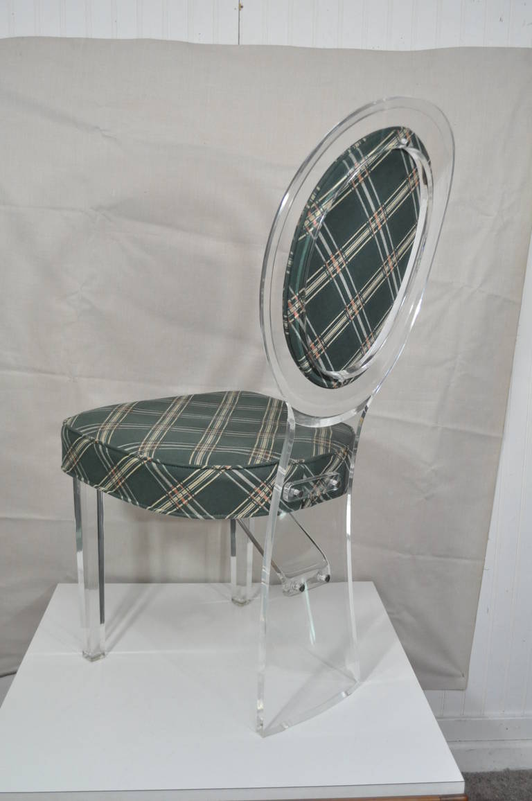 Elegant Vintage Hollywood Regency or Mid-Century Modern Lucite Side or Vanity Chair attributed to Charles Hollis Jones for Hill Mfg. The chair features a sleek elegant oval back terminating at a wide single rear support, and two slightly tapered