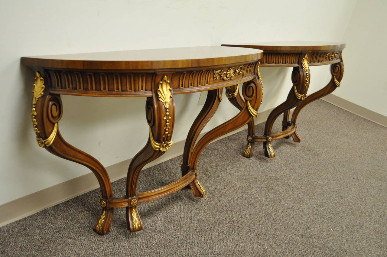 Pair of Remarkable Quality Wall Mounted Consoles or Hall Tables by Karges. The pair features solid walnut frames with banded burl walnut tops, gold gilt accents, carved drape forms, shell decorated carved skirts, and high quality construction as to