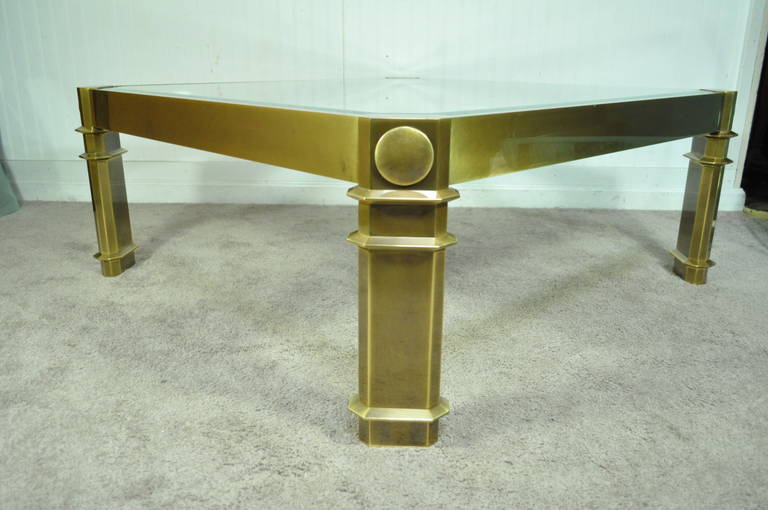 Substantial and Rare Vintage Antiqued Brass and Beveled Glass Square Coffee Table by Mastercraft. Table features four shapely neoclassic style legs with roundel and band accents. The top features a inset beveled glass top and an overall stunning