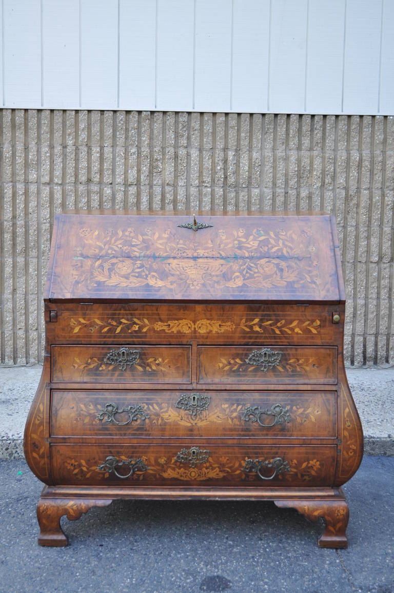 Antique Dutch marquetry hand inlaid bombe form drop front desk or secretaire, circa 1790. This remarkable item is heavily inlaid throughout including a beautiful console table with floral arrangements mounted on the top which is inlaid into the