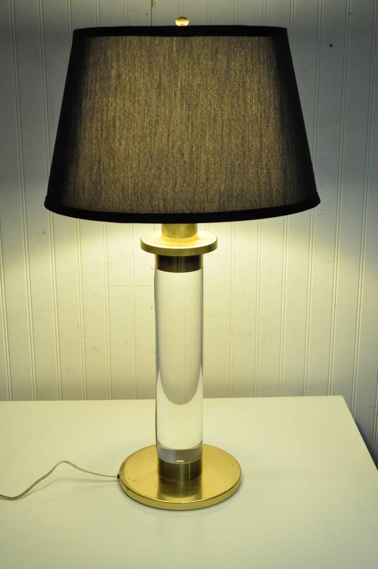 Mid-Century Modern Solid Lucite or Acrylic and Brass Vintage Single Table Lamp in the manner of Karl Springer. This rare modernist item features a brass capped and based solid lucite cylindrical body with hidden wiring which runs along the side of