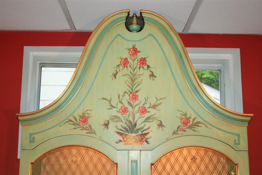 Beautiful 2 Piece Paint Decorated 2 Door Curio by John Widdicomb. Item features wonderful hand painted decoration on the front and sides, gold leaf, large scale bonnet top, brass lattice on the doors, bracket feet, glass shelves, and interior