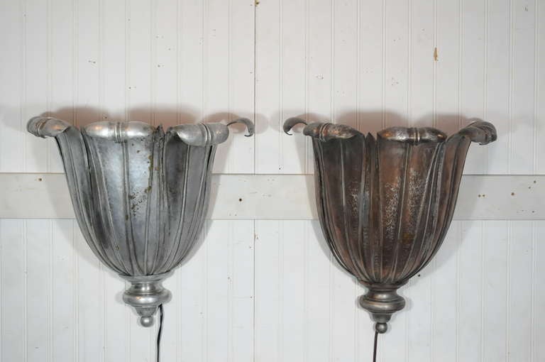 Remarkable Pair of French Art Deco Hand Hammered Copper Lotus Form Up-Light Electrified Wall Sconces Attributed to Maison Jansen. Sconces have remarkable form, substantial size, and great patina to the aged copper with one sconce having a more rich