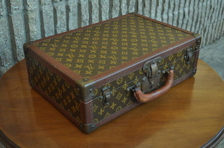 Beautiful Vintage Louis Vuitton Hard Case Suitcase Circa 1930. This wonderful piece features LV embossed leather trim around the entire border of the case, brass hardware, and 2 original LV leather key cases with keys. This particular piece was