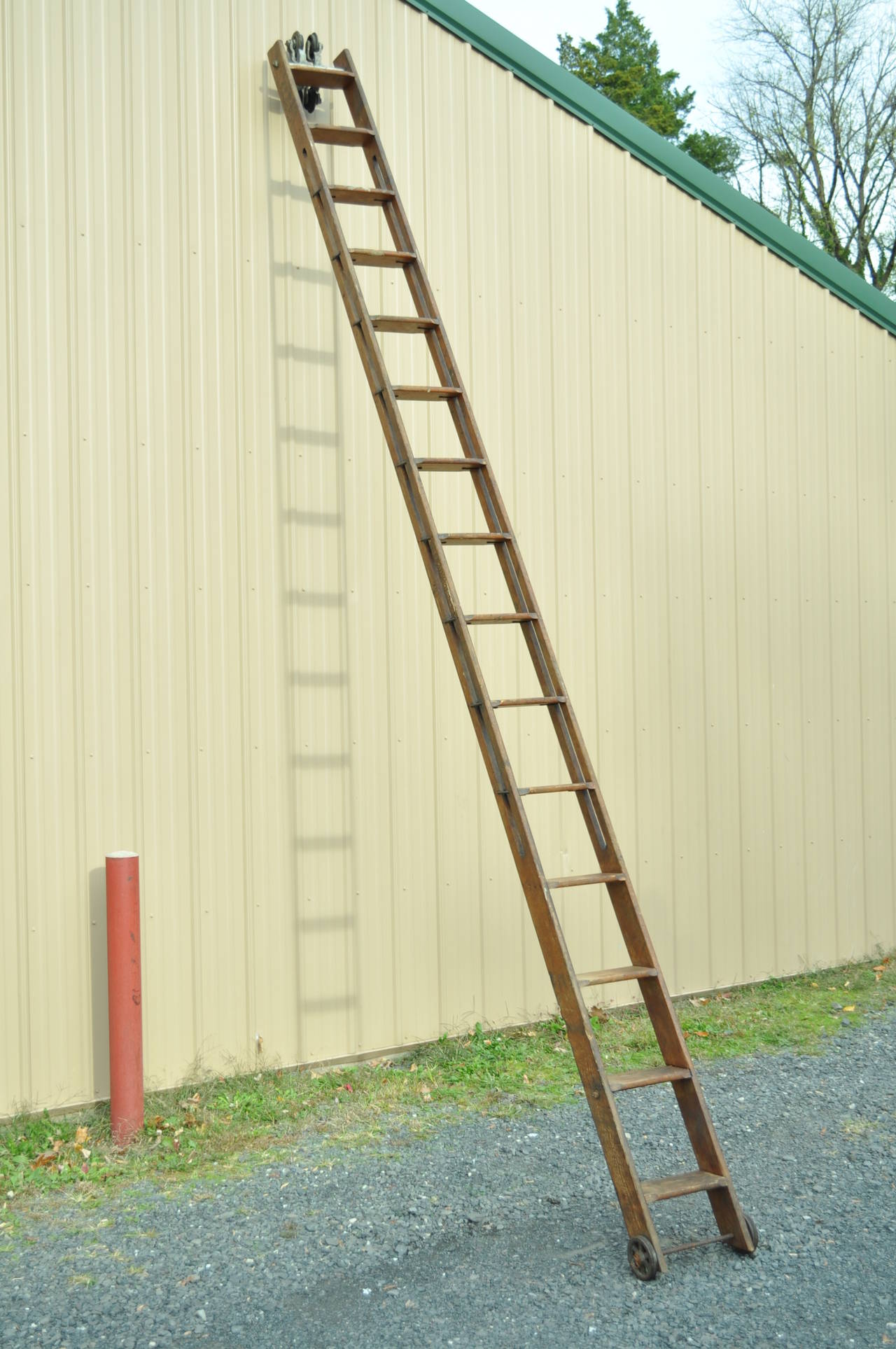 Stunning 19th Century F.E. Myers & Bros. Rustic Ladders with heavy duty, cast iron, rolling hardware attached to the top of each ladder. These original antique pieces came out of a NJ General Store and were in use for over 100 years. Each ladder has