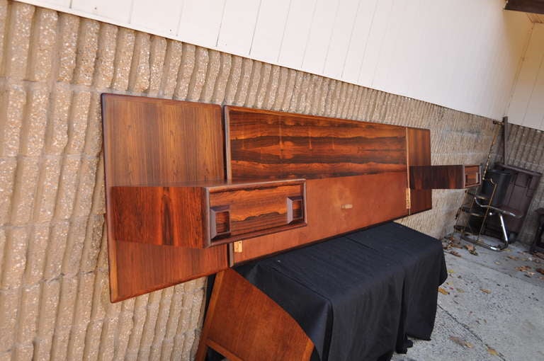 Breathtaking Mid Century Modern Rosewood and Teak Wall Mounted Floating Form King Size Headboard with attached Matching Floating Form Nightstands by Inter-Continental Design Limited of Canada in the Arne Vodder / Danish Taste. Floating Nightstands