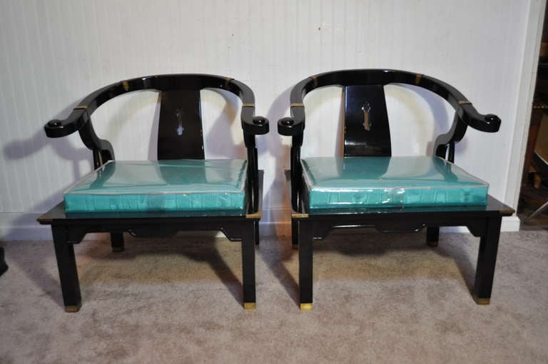 Classy pair of vintage James Mont Style Oriental Armchairs with Brass Accents, Black Lacquer Frames, and Beautiful Blue Fabric Still Covered in The Original Plastic with Matching Pillows.
