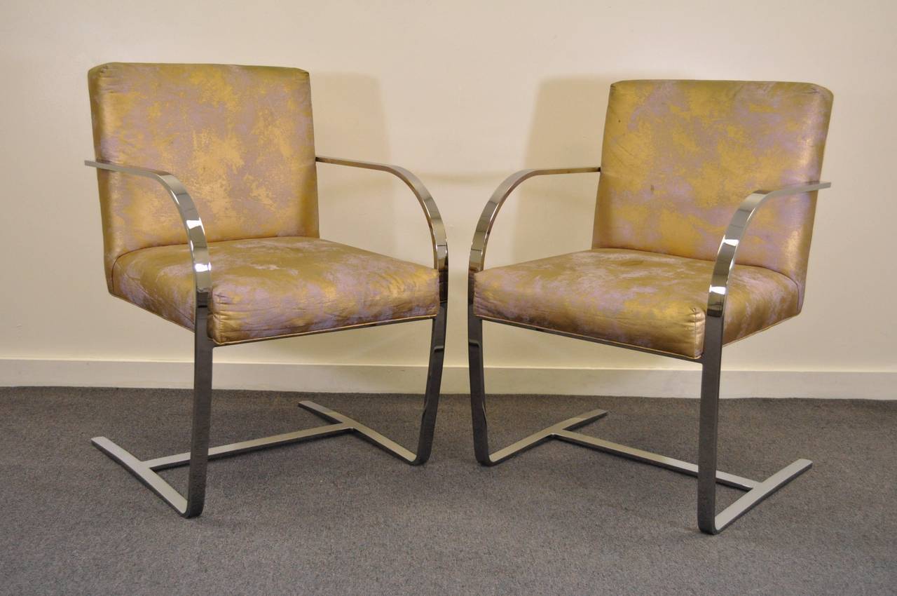 Quality pair of vintage flatbar chrome-plated steel cantilever armchairs by Cy Mann of NYC in the Knoll Mies van der Rohe, Brno style. This vintage pair of chairs features heavy seamless construction and Classic modernist form. Original fabric is