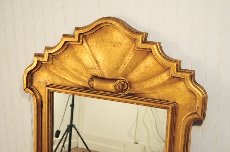 Beautiful Vintage Circa 1940s Gold Carved Wood Wall Mirror with Scrolled Shell Form Crown. This fine item is unmarked but believed to be of Italian origin with a beautifull antiqued/distressed finish to the gold frame. This classy mirror is in great