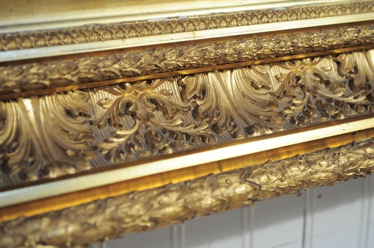 Beautiful Antique 19th Century Gold Gilt Wall Mirror with Greek Anthemion decorated shallow wood frame. This fine piece features remarkable original gold gilt gesso detailing to the wood shadow box frame.