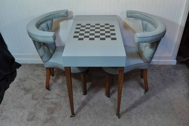 Very rare and remarkable 1940's bluish grey leather 3 piece game table set in the Ed Wormley / Dunbar Style. This beautiful set features a blue tooled leather game table with reversible top, pair of unique distressed tufted leather cock fighting