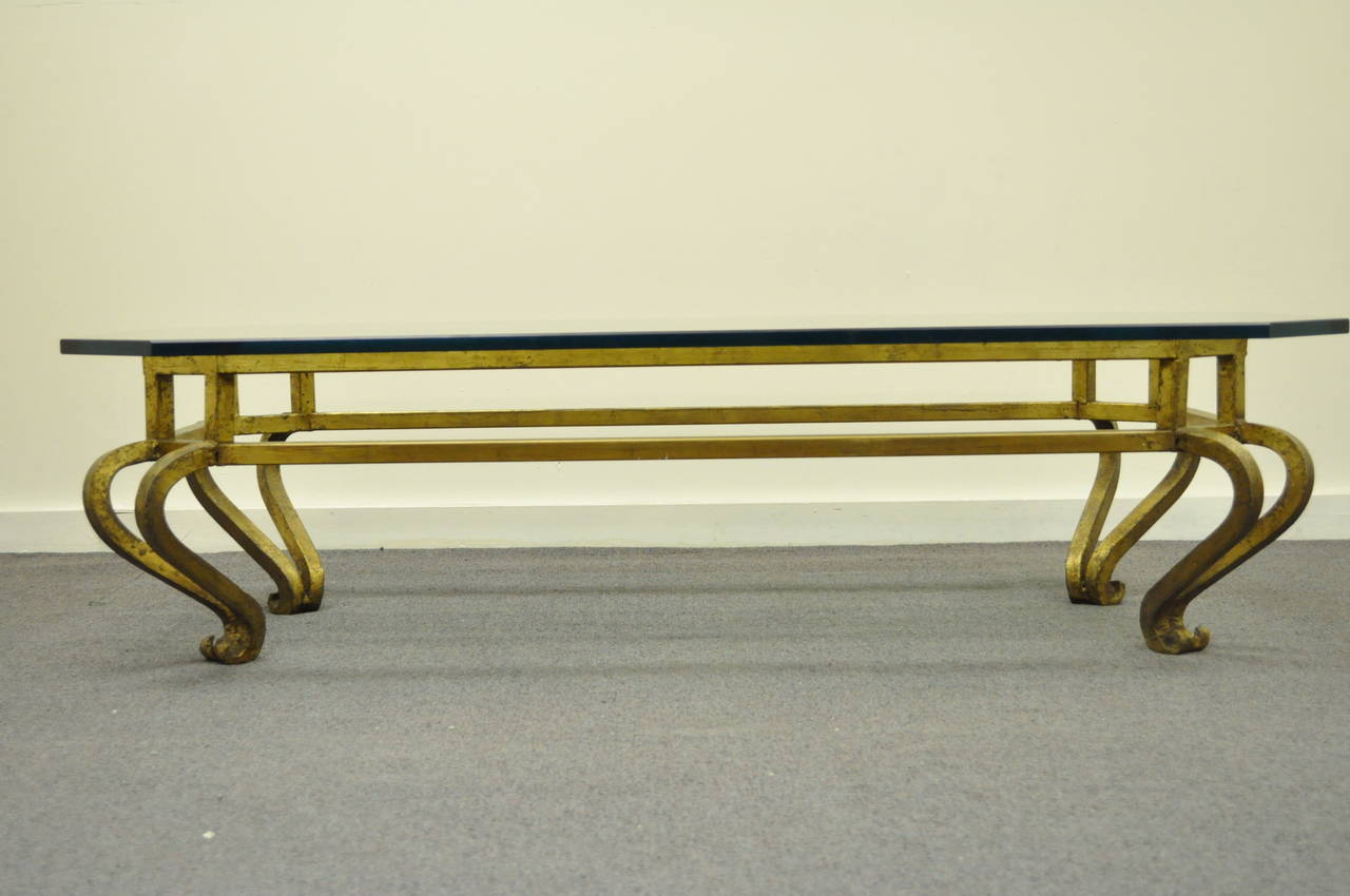 Very unique, high quality, gold gilt iron coffee table with exaggerated scrolling legs and a thick .75